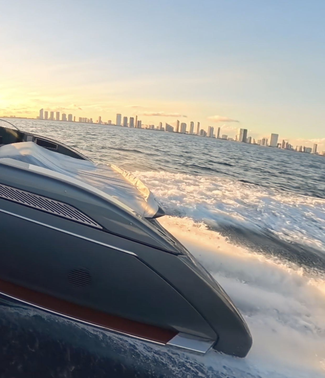 Bow of a Riva 68 Diable cutting through open water at sunset