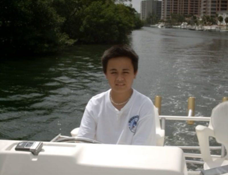 Luis Sotero as a boy at the helm on a Miami river